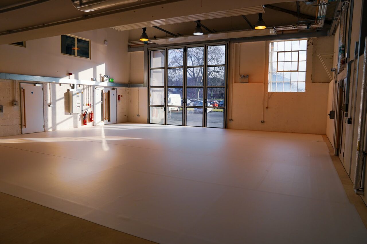 Studio space with white dance floor.